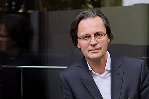 Mann mit Brille schaut in die Kamera